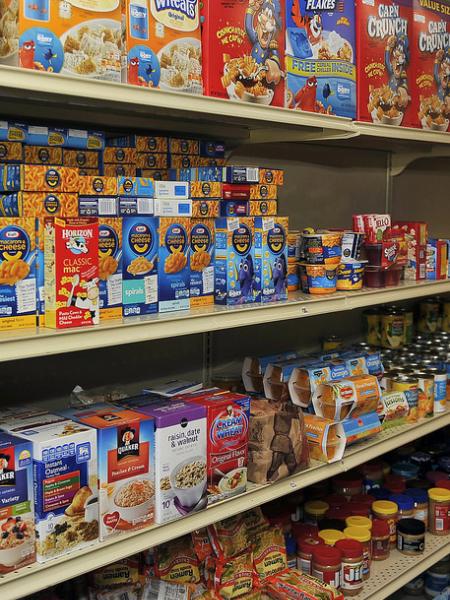 Shelves full of boxed food items like cereal and macaroni & cheese.